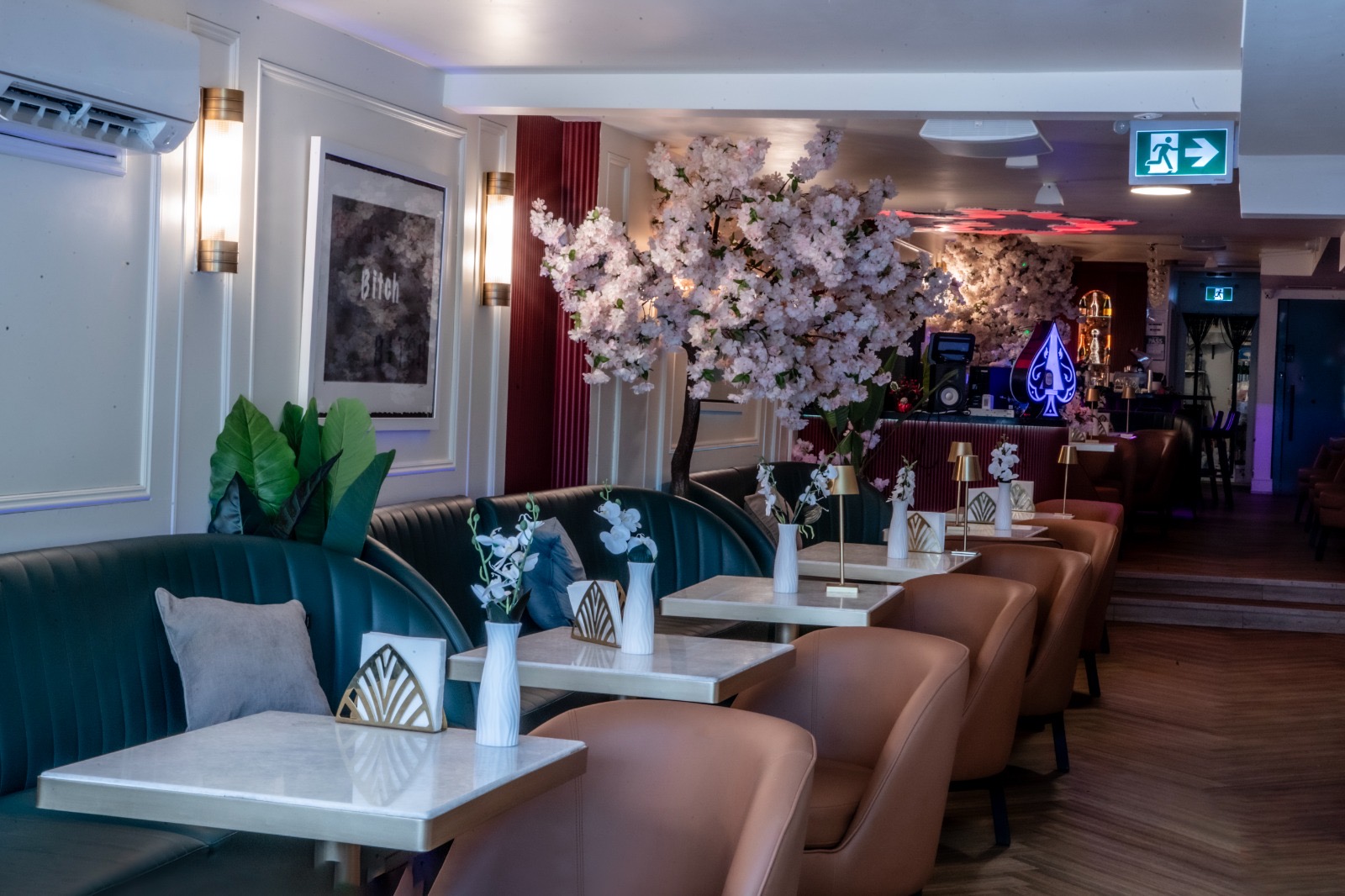 Art deco bar lit by blossoms with Ace of Spades centerpiece